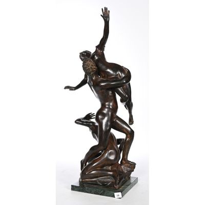 a bronze statue of a man wrestling a woman on a marble base