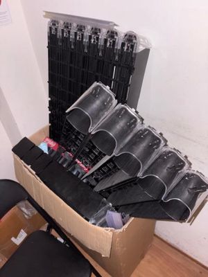 a cardboard box with a bunch of black umbrellas in it