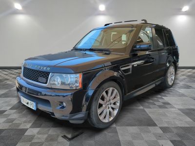 a picture of a black land rover parked in a garage