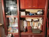 a bookshelf with a lot of books on it in a room