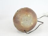 a piece of bread on a wire on a white surface