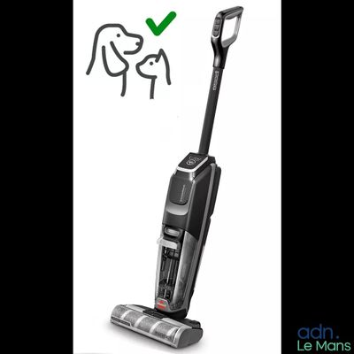a black and white photo of a vacuum cleaner with a green tick