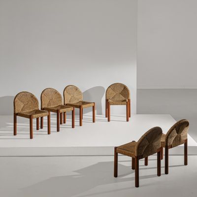 several chairs are arranged in a row on a white surface