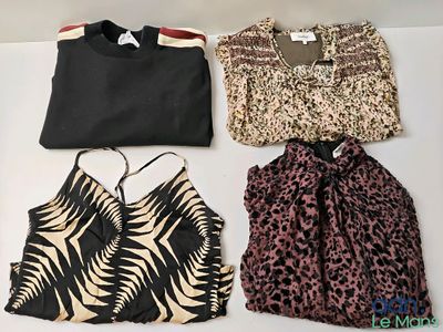 three tops and a bag are sitting on a white surface