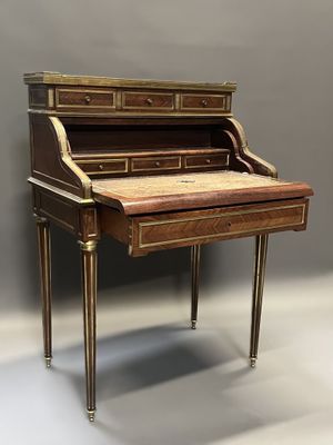 un bureau ancien avec un plateau en bois et des finitions dorées