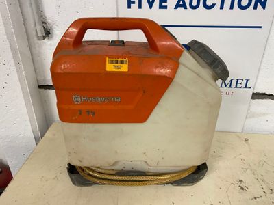 an orange and white gas can sitting on a table