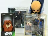 several star wars action figures are displayed on a white surface