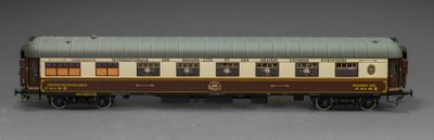 un wagon marron et blanc posé sur une surface grise