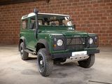 an image of a green land rover parked in a garage