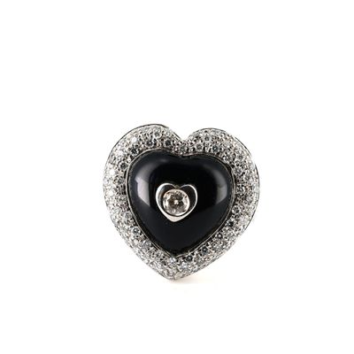 a close up of a heart shaped black and white diamond ring
