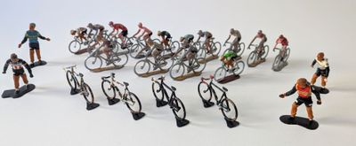 many figurines of people riding bikes on a white surface