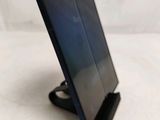 a small black tablet on a stand on a white surface