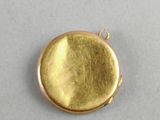 a close up of a gold locke on a white surface