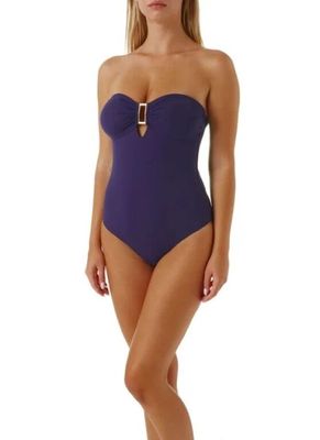 the woman in the purple swimsuit is posing for the camera