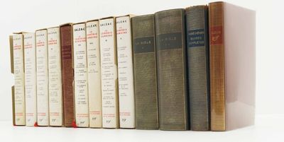 books are lined up in a row on a white surface