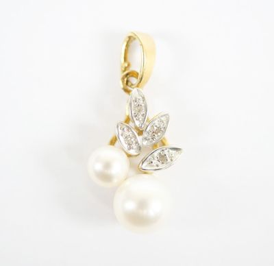 a close up of a pearl and diamond pendant on a white background