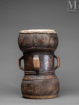 a small wooden drum with two handles on top of it