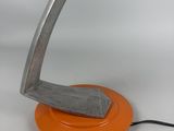 an orange lamp that is on top of a table