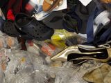 a pile of clothes and shoes in a plastic bag