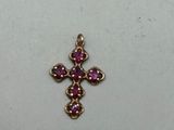 a close up of a small cross on a white surface