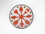 a red and white plate with green dots on it
