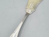 silver plated serving spoon with a flower design on the handle