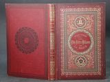 a red book with gold trimming and a red cover