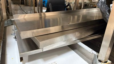 a large stainless steel sink in the middle of a room