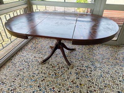 an image of a dining room table with a glass door in the background