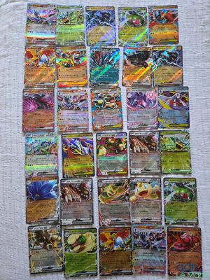 a pile of pokemon cards sitting on top of a table