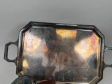 a silver tray with a mirror on it on a table