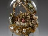 une cloche en verre contenant un bouquet de fleurs