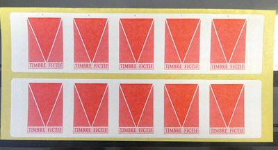 a close up of four red and white stickers on a table