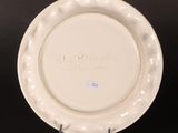an image of a white plate with writing on it sitting on a black surface