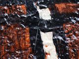 a close up of a painting of a cross on a wall