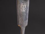 a close up of a spoon with a metal handle on a black background