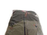 a bag of clothing wrapped in plastic on a white surface