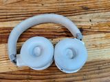 a pair of headphones that are on a wooden table