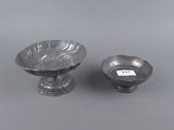 a pair of silverplated bowls and a bowl on a stand