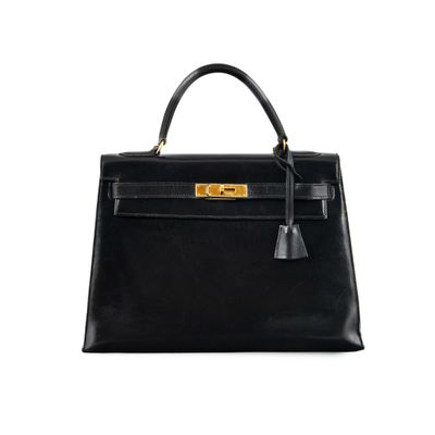 a black leather handbag on a white background