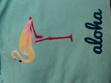 a close up of a shirt with a flamingo on it