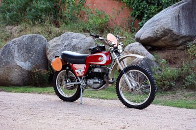a red dirt bike parked on the side of the road