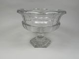 a glass vase with a glass base on a white surface