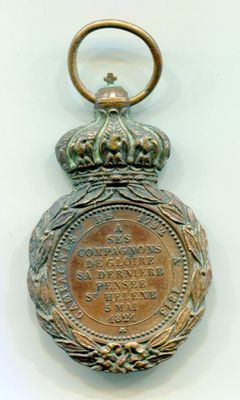 une vieille médaille en bronze surmontée d'une couronne