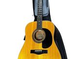 an acoustic guitar with a case on top of it
