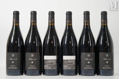 six bottles of wine are lined up in a row on a table