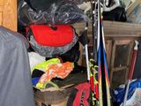 a pile of skis and ski poles in a storage area