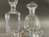 two glass bottles sitting next to each other on a table