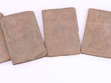 six pieces of brown paper sitting on top of a white surface