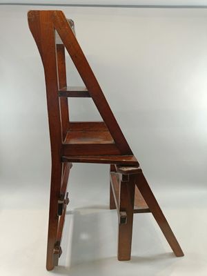 a wooden chair with a ladder on top of it